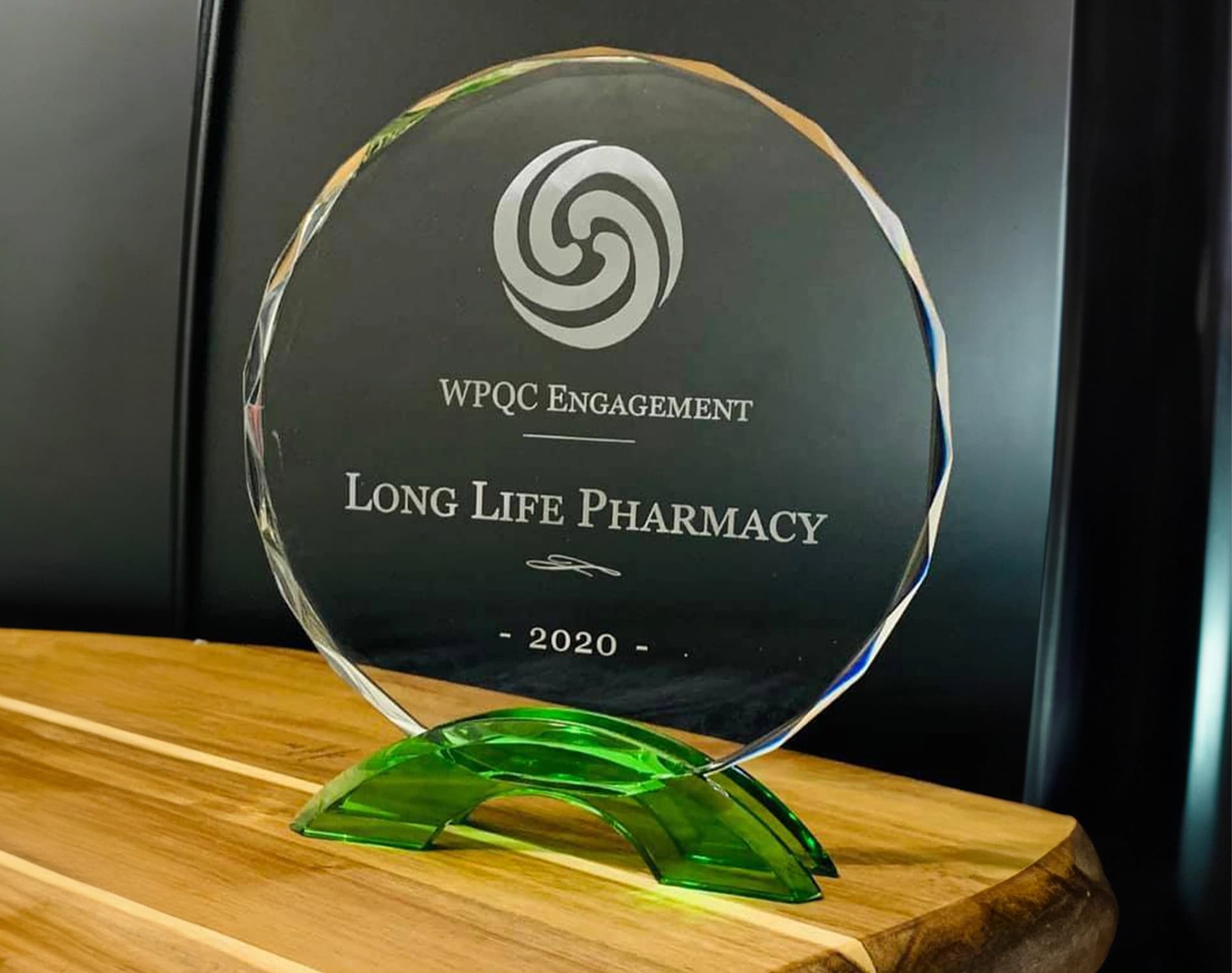 Inside Long Life Pharmacy, a pharmacist filling a prescription at the counter